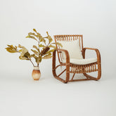 Side profile of Safi Rattan Armchair highlighting natural rattan frame